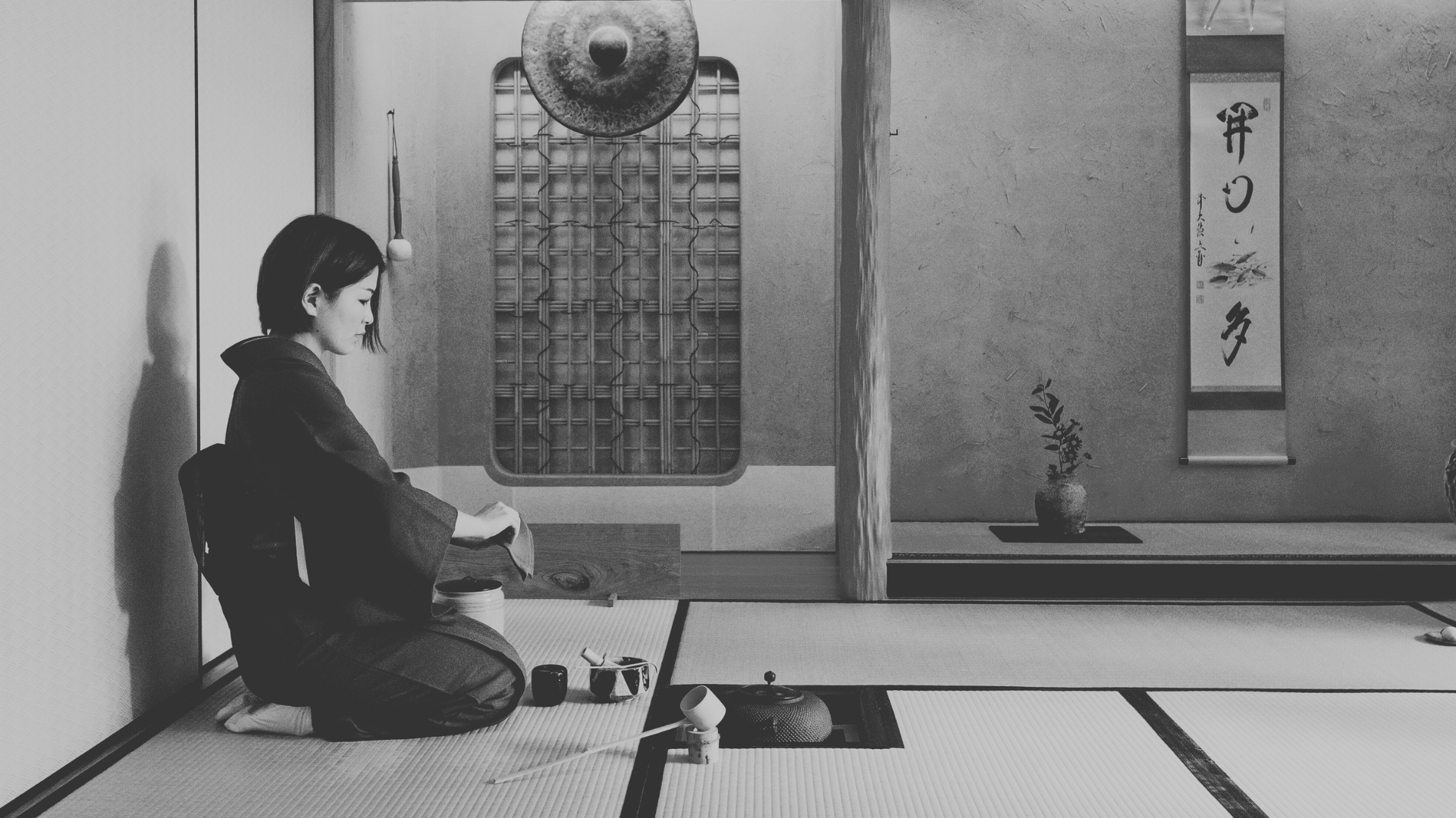 Woman practicing the Japanese tea ceremony in a tatami room Woman practicing the Japanese tea ceremony in a tatami room