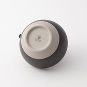 Bottom view of Origami matcha bowl made in Japan, showing natural clay base and subtle brand imprint.