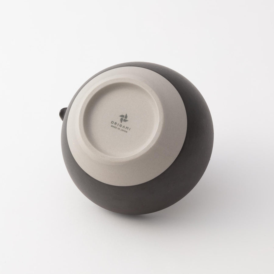 Bottom view of Origami matcha bowl made in Japan, showing natural clay base and subtle brand imprint.