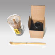 Japanese bamboo matcha whisk set with 100-prong chasen, ceramic stand, and chashaku scoop in individual protective packaging