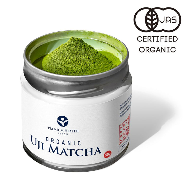 Open 50g tin of Premium Health Japan organic Uji matcha with JAS certified organic logo, showing vibrant green powder.