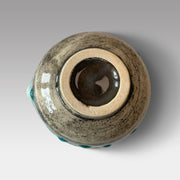 Bottom view of blue Nagashi matcha chawan showing raw clay foot and textured stoneware base with handcrafted glaze finish