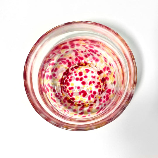 Top view of glass matcha bowl with pink and gold sakura-style speckled pattern, ideal for modern Japanese tea rituals