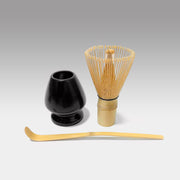 Japanese matcha tea whisk set with 100-prong chasen, black ceramic whisk holder, and bamboo chashaku scoop