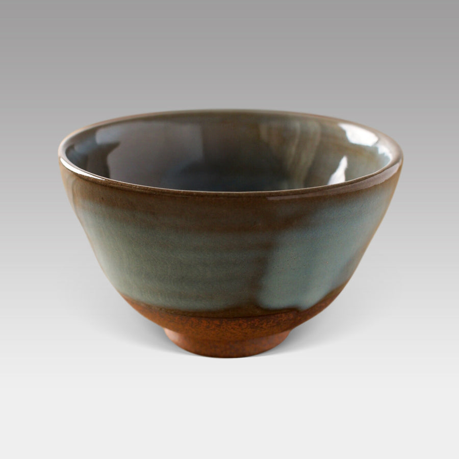Handcrafted Mashiko-style matcha bowl with earthy blue-green glaze and rustic red clay base, made in Japan.