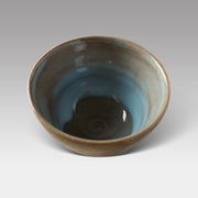 Top view of Mashiko-style matcha bowl showing smooth spiral base and glossy blue-green glazed interior, handcrafted in Japan.
