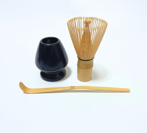 Matcha whisk set with bamboo chasen, black whisk holder, and bamboo scoop on white background