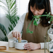 Woman whisking matcha in a bowl