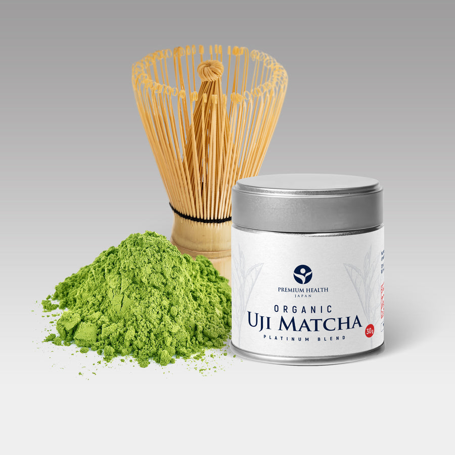 Organic Uji Matcha Platinum Blend can beside fresh matcha powder and bamboo whisk, ideal for tea ceremony or matcha latte