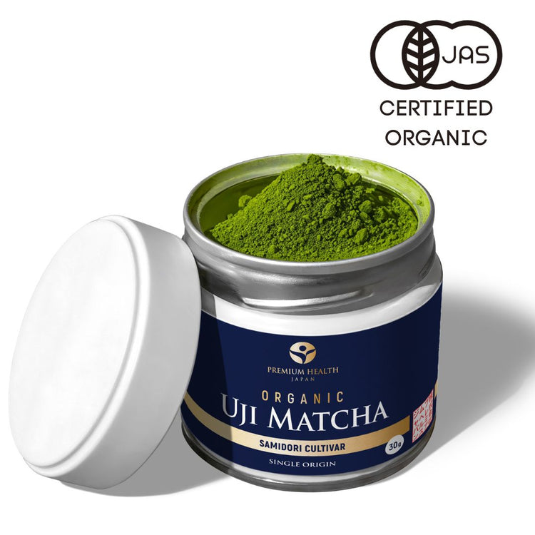 Open tin of organic Uji matcha powder from Premium Health Japan, Samidori cultivar with JAS certified organic logo.