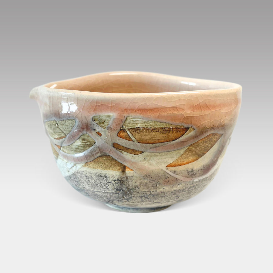 Handcrafted Japanese matcha bowl with pink nagashi glaze and textured finish, ideal for traditional tea preparation.