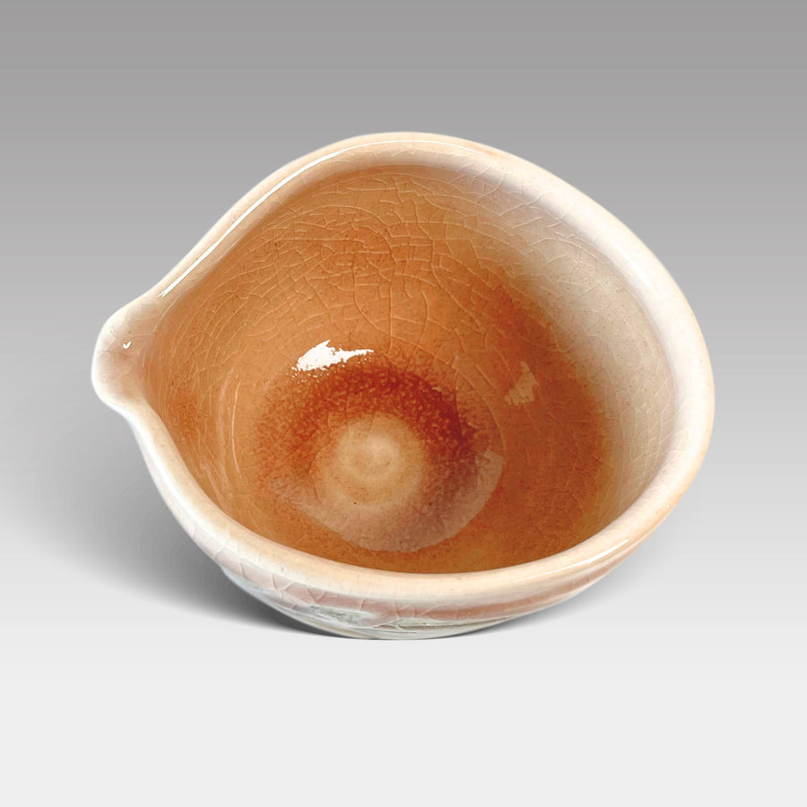 Top view of handcrafted pink nagashi matcha bowl with warm glazed interior and pouring spout, made in Japan.
