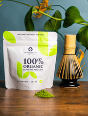 100% Organic Japanese Matcha 50g pouch displayed with matcha whisk and green tea powder, premium ceremonial grade by Premium Health Japan.