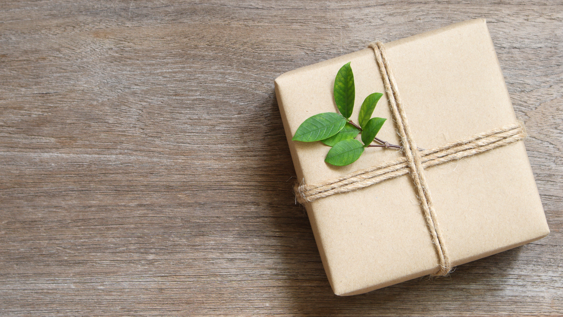 A wrapped gift with tea leaves as decoration