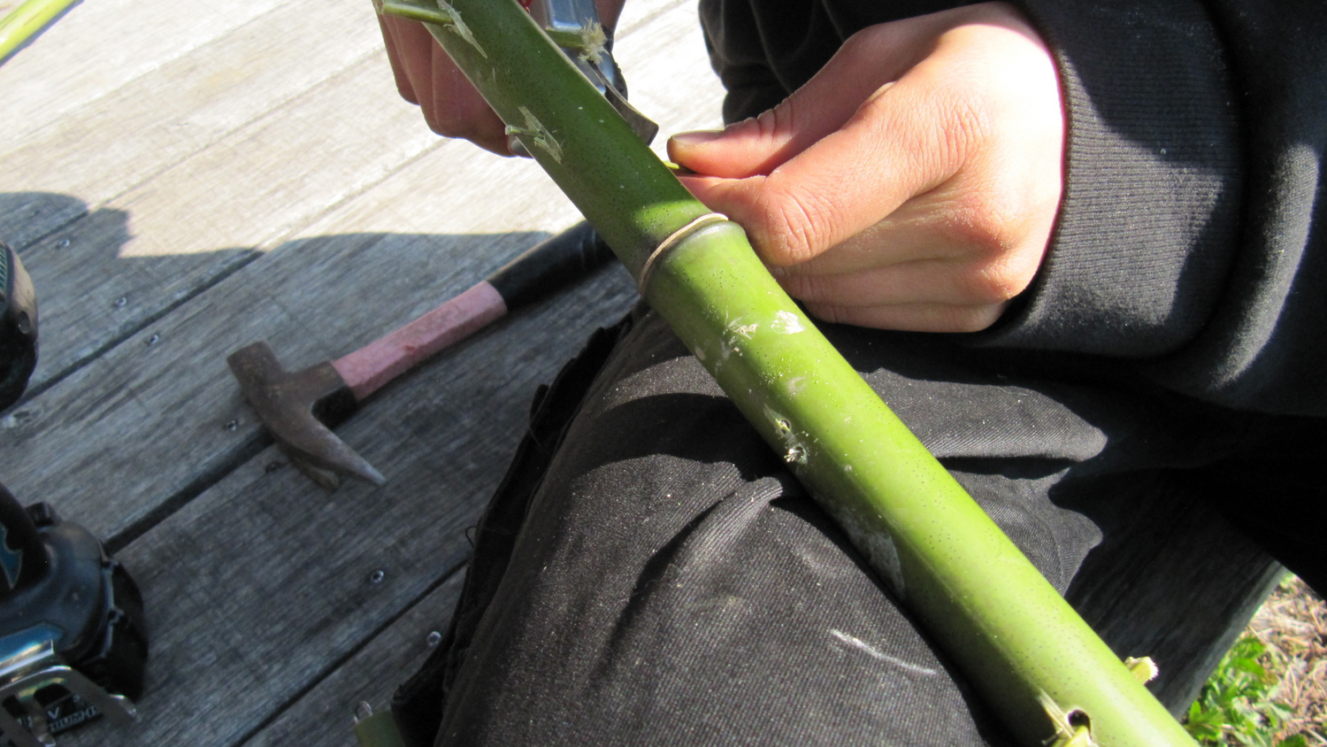 Man crafting bamboo into a matcha whisk