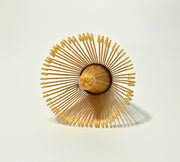 Top view of 100-prong bamboo matcha whisk (chasen) showing finely crafted loops on white background