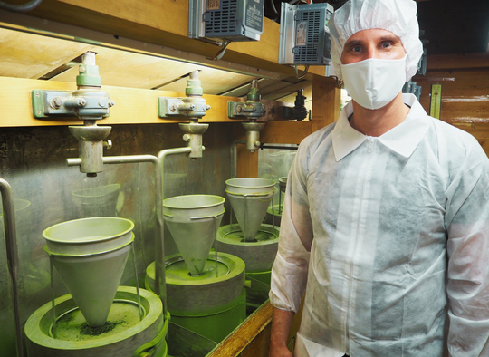 Founder of Premium Health Japan in the stone-grinding room of a matcha factory