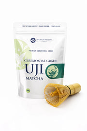 Ceremonial Grade Uji Matcha 100 g pouch with a bamboo chasen placed beside it.