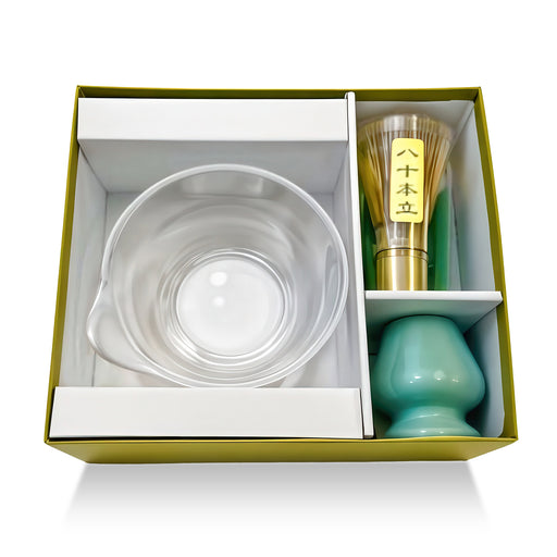 Matcha gift set with clear glass bowl, Japanese bamboo whisk, and green ceramic holder in elegant presentation box