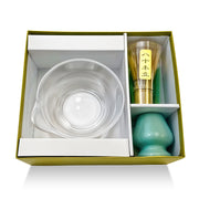 Matcha gift set with clear glass bowl, Japanese bamboo whisk, and green ceramic holder in elegant presentation box