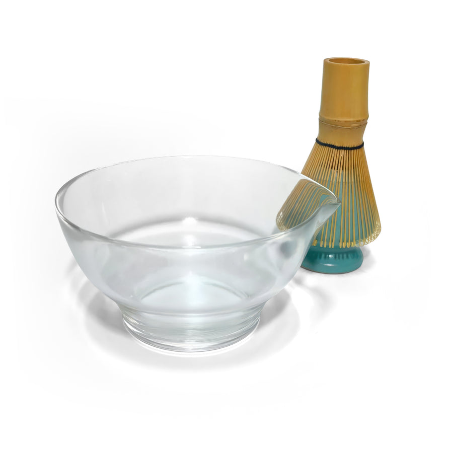 Glass matcha bowl with pouring spout shown beside bamboo chasen on green ceramic holder, ideal for modern tea preparation