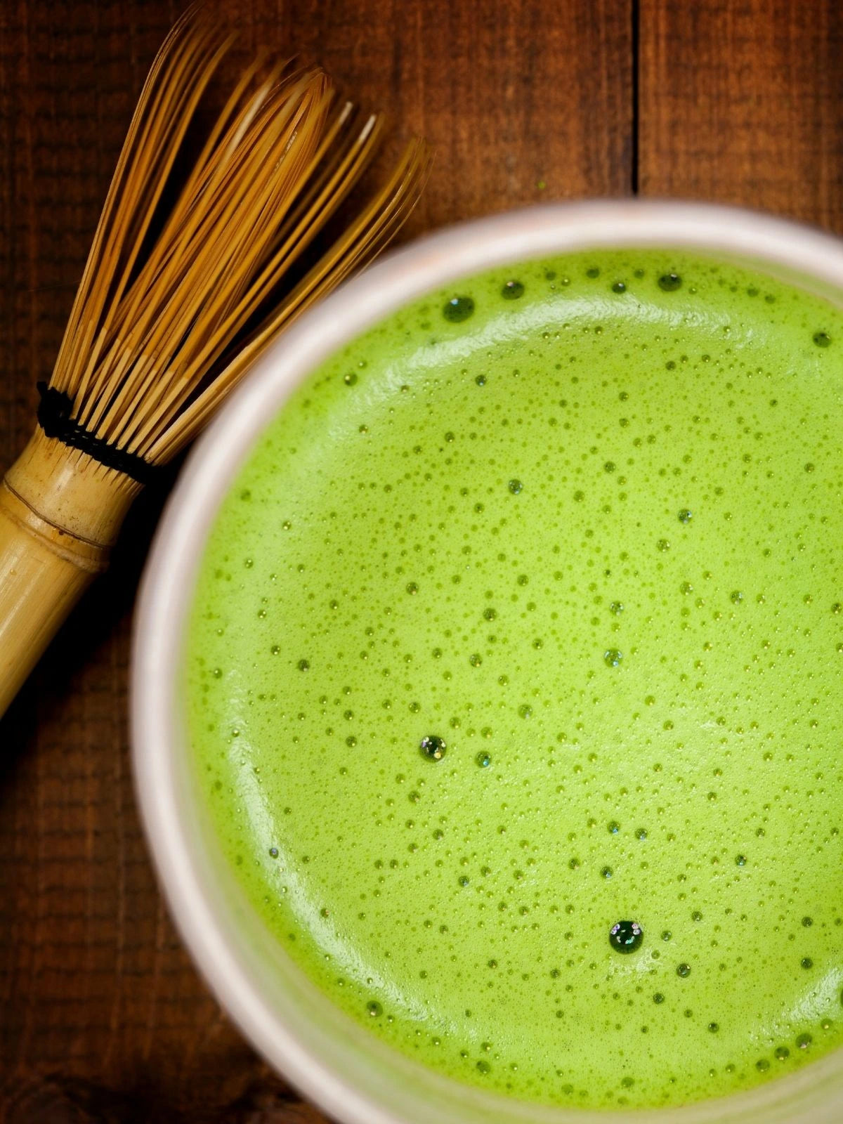 Prepared Japanese matcha with a smooth, creamy foam, served with a traditional bamboo whisk