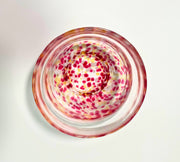 Top view of Japanese glass matcha bowl with pink, red, and yellow plum blossom pattern