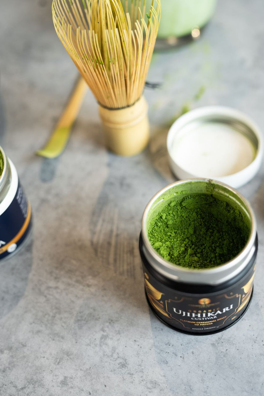 View of an opened can of organic matcha powder focusing on the vibrant green color 