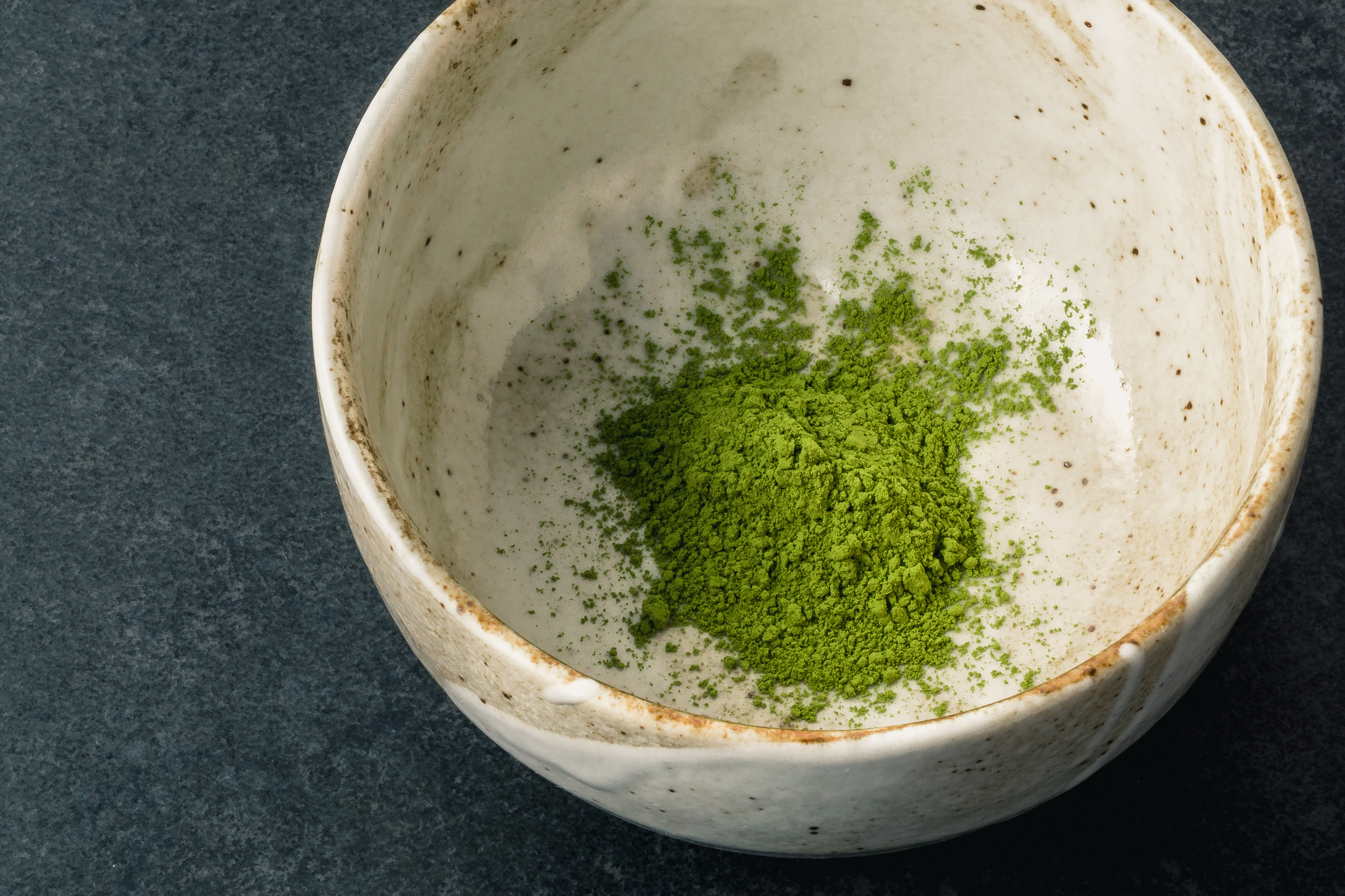 Chawan matcha tea bowl with green matcha powder inside