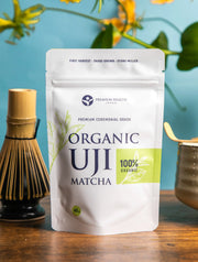 Organic Uji Matcha 40g ceremonial grade pouch displayed with whisk and matcha bowl on a wooden table