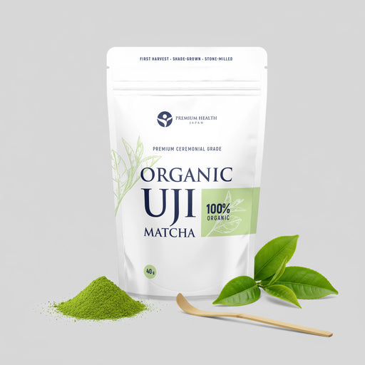 Organic Uji matcha 40 g pouch with matcha powder and fresh tea leaves displayed beside a bamboo chashaku on a light background.