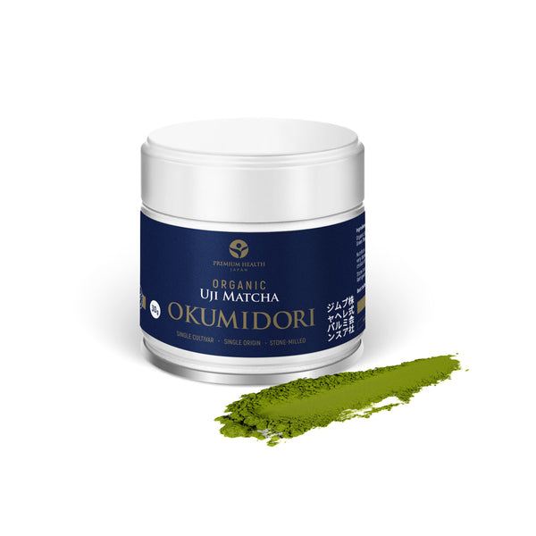 Organic Uji Matcha Okumidori 30 g jar with navy label, beside a swept line of deep green stone-milled matcha powder