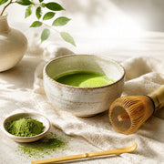 Traditional usucha matcha prepared in a rustic ceramic chawan with a bamboo chasen whisk and chasaku scoop — organic Uji matcha from Premium Health Japan