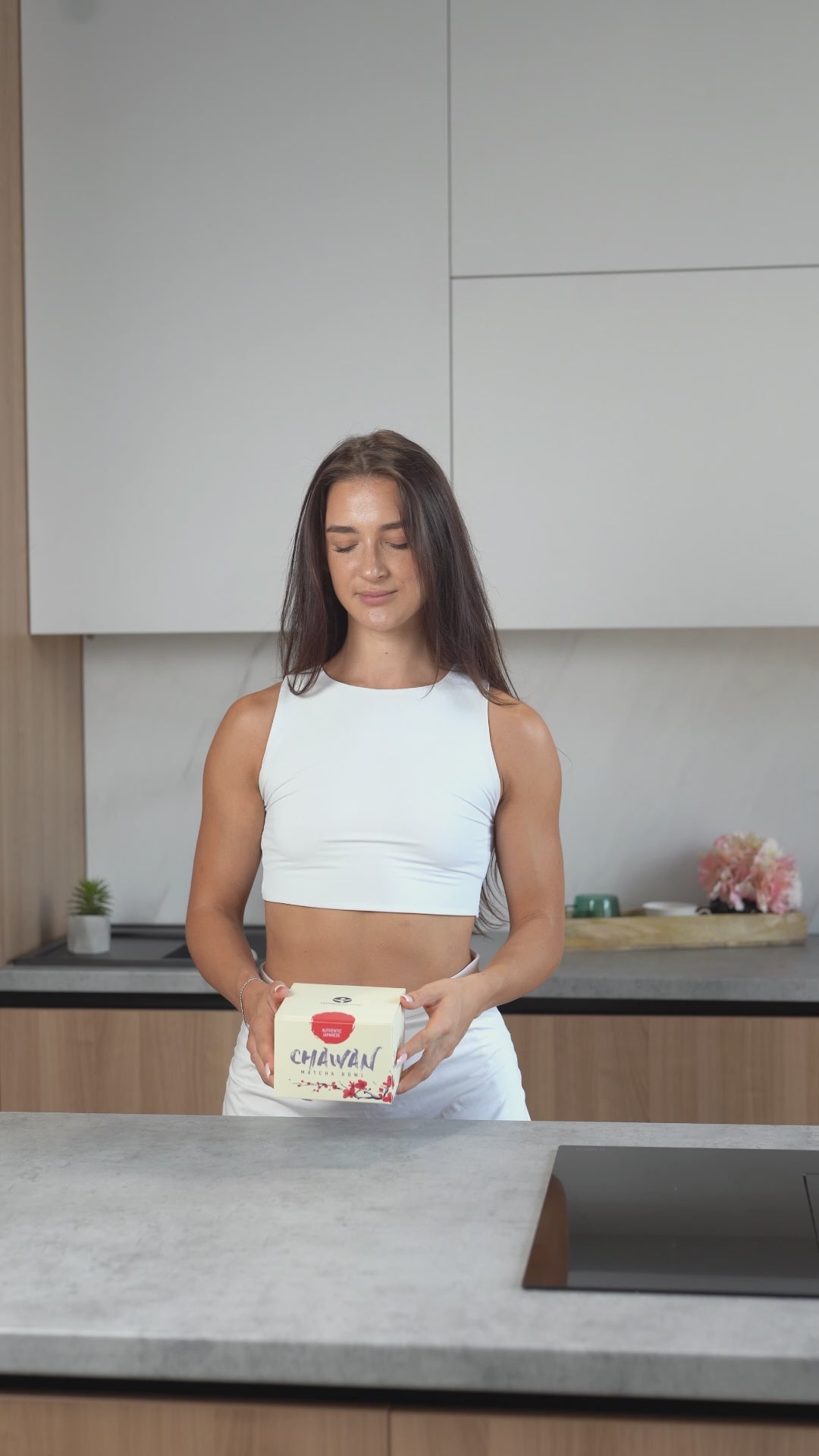 Woman unboxing a Japanese made chawan matcha bowl from Premium Health Japan