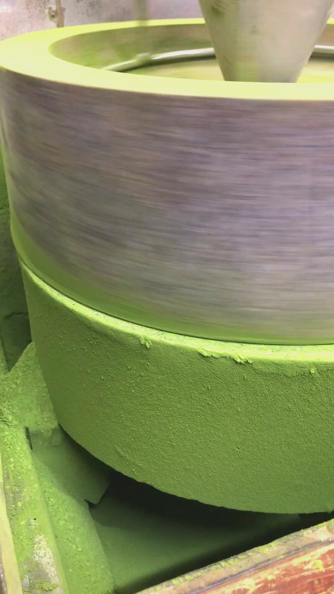 A stone-grinder producing matcha powder