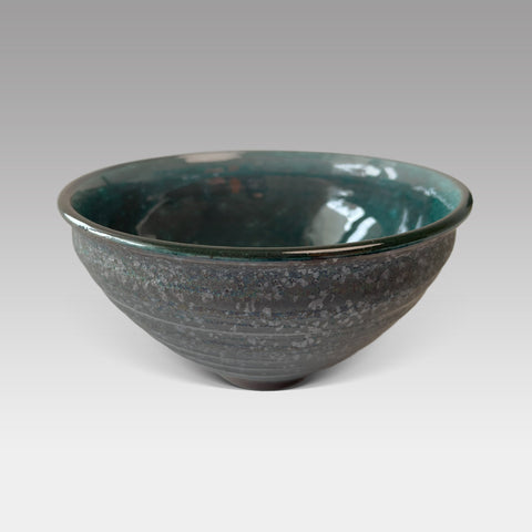 Side view of teal-glazed Japanese matcha chawan with textured stoneware finish, handcrafted for traditional tea preparation