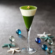Matcha dessert in a tall glass flute made with Uji Matcha Asahi — green matcha layer, white cream layer, dusted top with gold leaf
