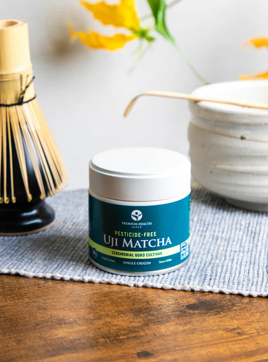 Pesticide-free Uji Matcha ceremonial Gokō cultivar can displayed with whisk and matcha bowl on a wooden table