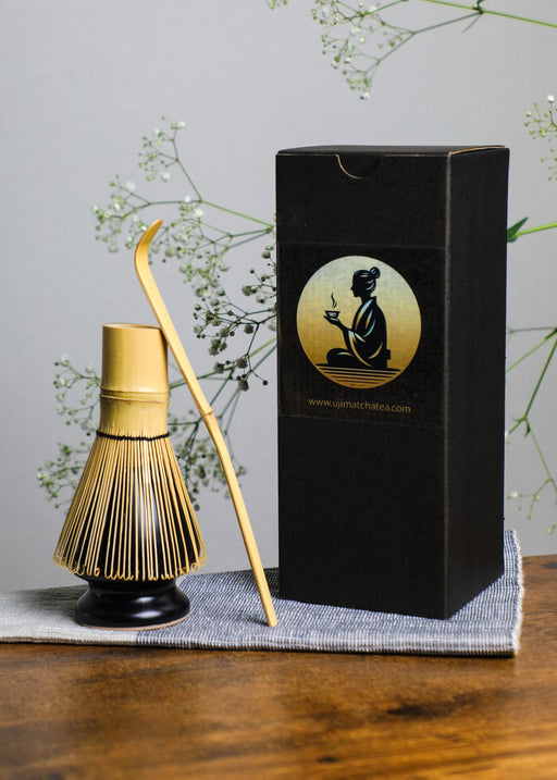 Handcrafted bamboo matcha whisk displayed with black Premium Health Japan gift box, representing authentic Japanese tea ceremony craftsmanship.