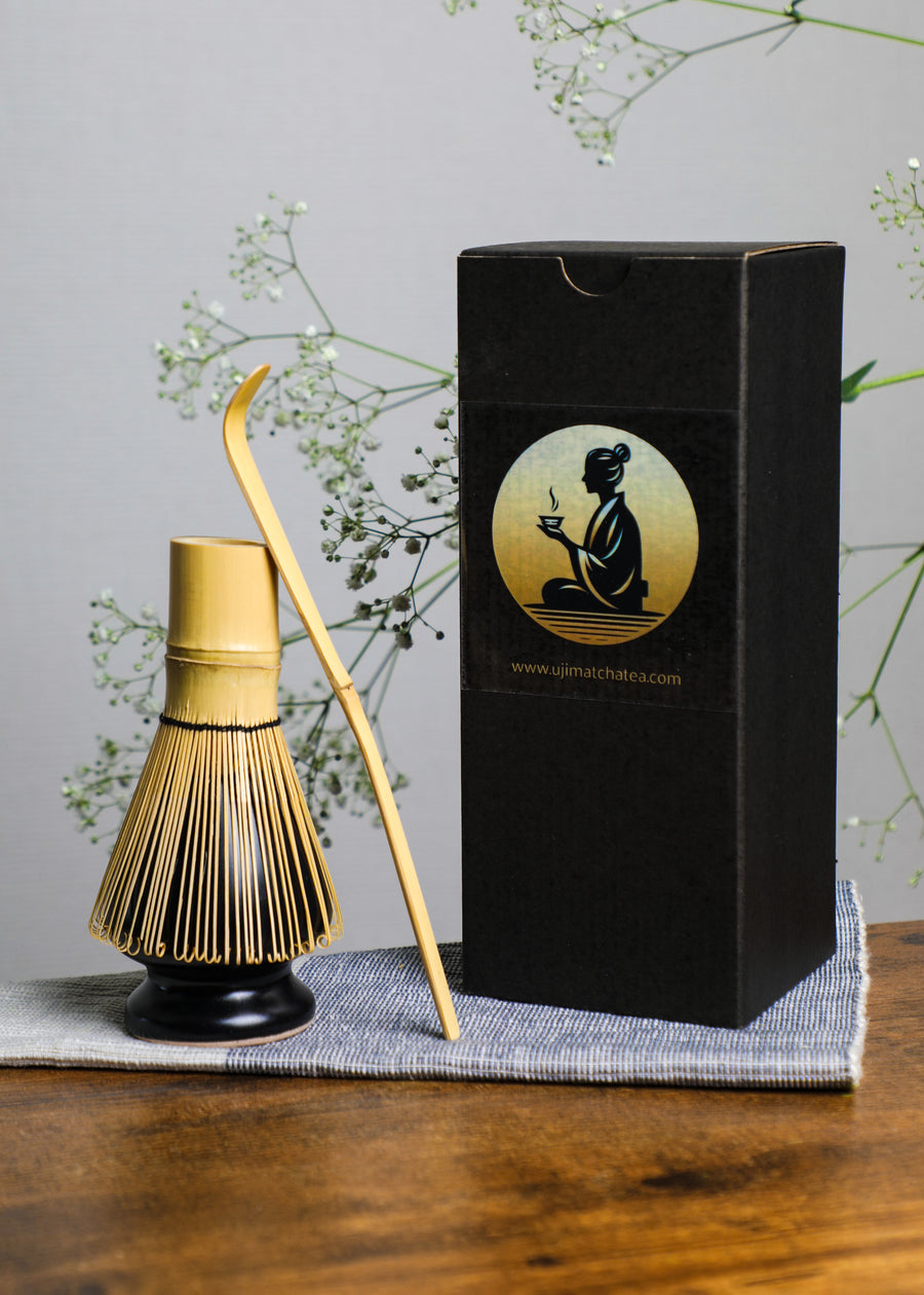 Handcrafted bamboo matcha whisk displayed with black Premium Health Japan gift box, representing authentic Japanese tea ceremony craftsmanship.